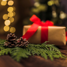 Fir branch with snag near gift box with red bow board MOYVALLECMS01